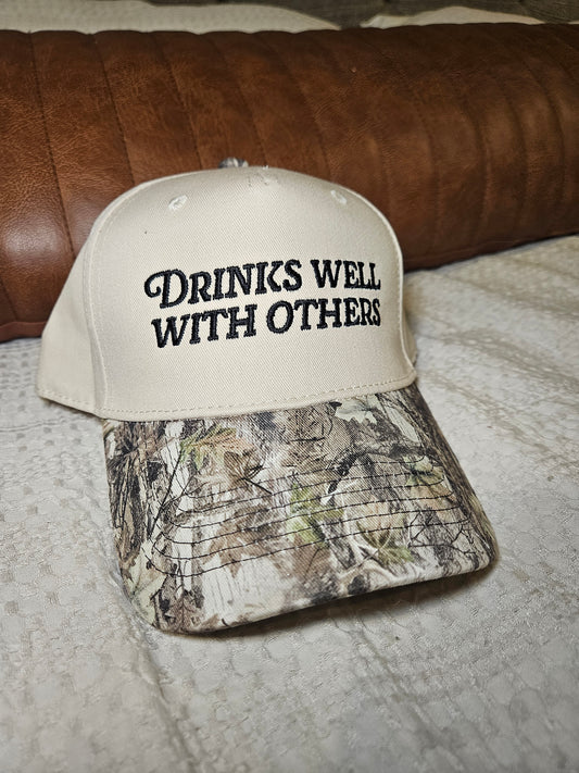 Drinks well with others trucker hat